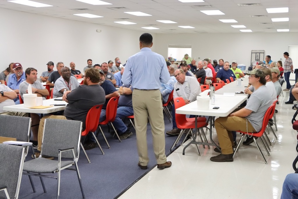 Superintendent speaking to Maintenance department in an open room