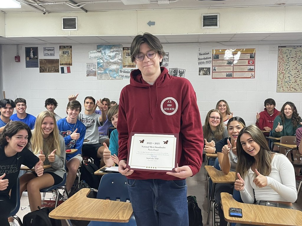 Nicholas Ford holding certificate in front of classmates