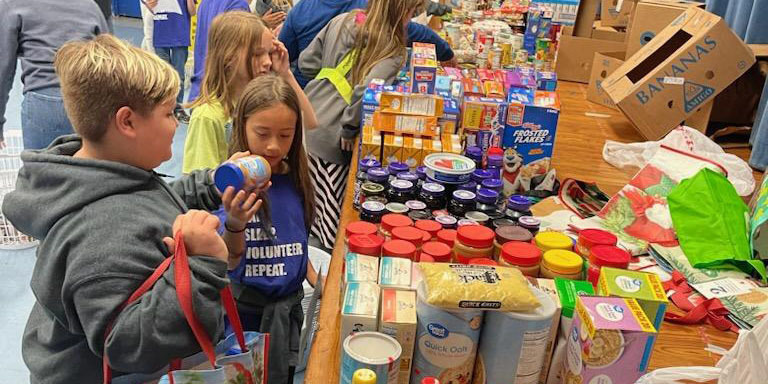 Students packing donated Thanksgiving items