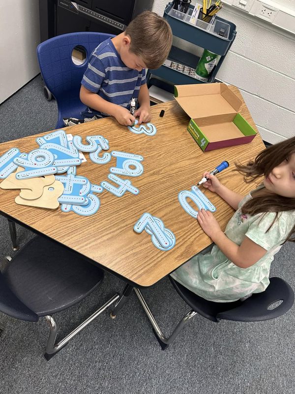 Two students working with numbers