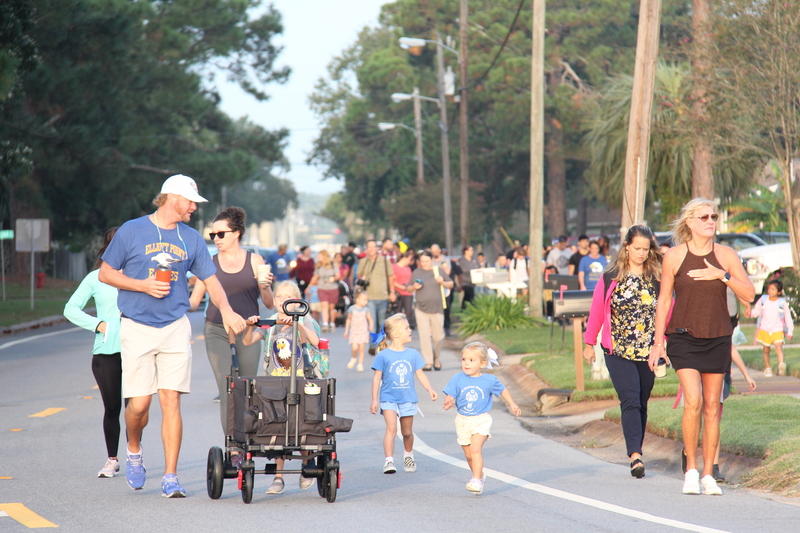 Students, families, and community members walking to school.